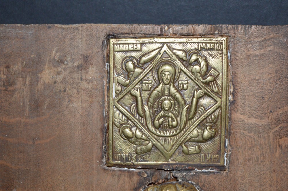 A rectangular wooden panel featuring three square brass Russian icons and a central relief of a winged angel head. View III