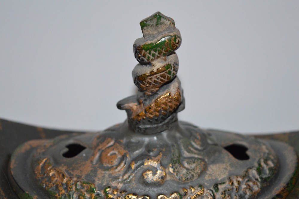 A late Qing dynasty dark parcel-gilt bronze censer featuring raised phoenix relief panels, extended vertical handles, and a serpent finial lid. View III
