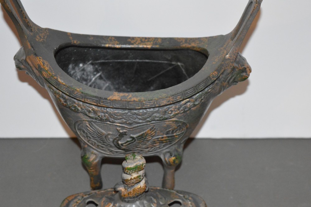 A late Qing dynasty dark parcel-gilt bronze censer featuring raised phoenix relief panels, extended vertical handles, and a serpent finial lid. View IV