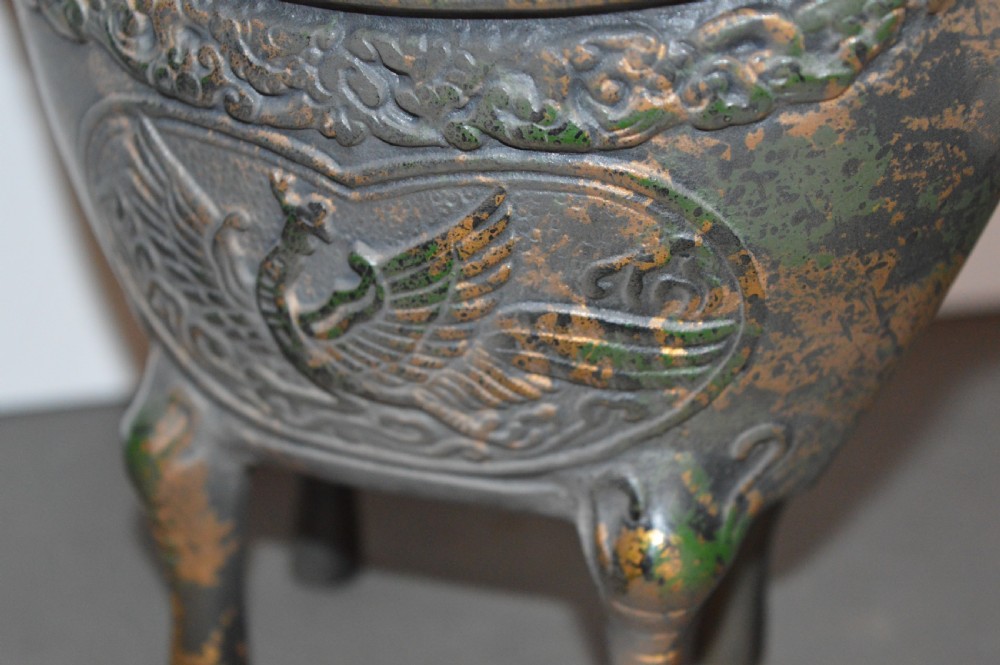 A late Qing dynasty dark parcel-gilt bronze censer featuring raised phoenix relief panels, extended vertical handles, and a serpent finial lid. View VIII