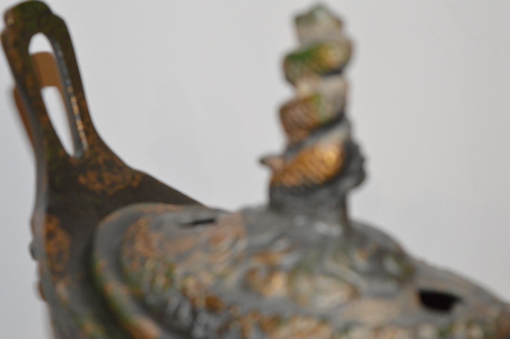 A late Qing dynasty dark parcel-gilt bronze censer featuring raised phoenix relief panels, extended vertical handles, and a serpent finial lid. View XI