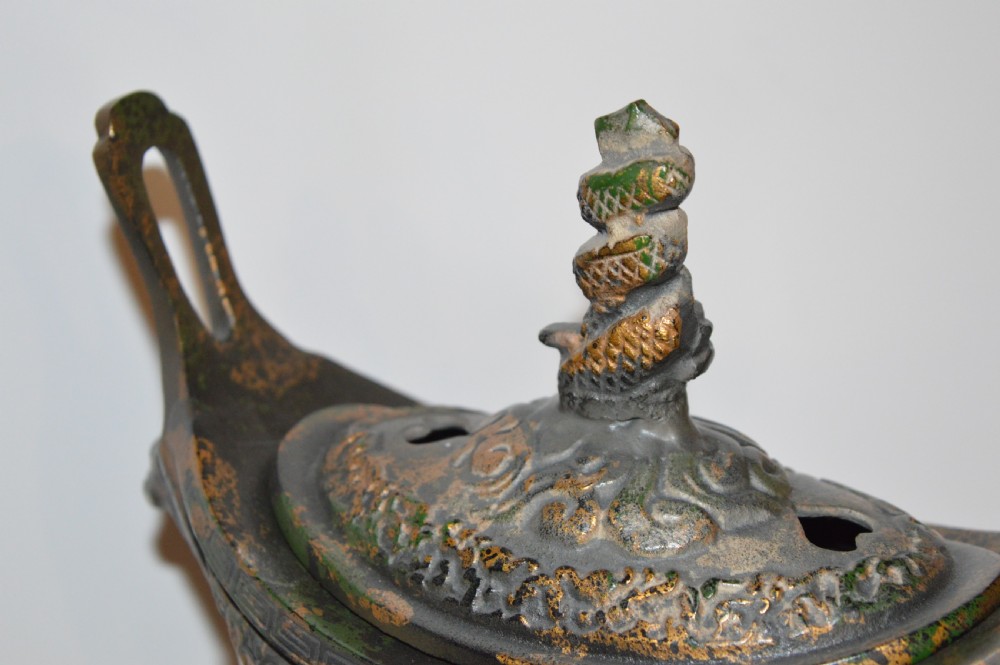 A late Qing dynasty dark parcel-gilt bronze censer featuring raised phoenix relief panels, extended vertical handles, and a serpent finial lid. View XII