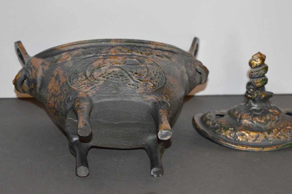 A late Qing dynasty dark parcel-gilt bronze censer featuring raised phoenix relief panels, extended vertical handles, and a serpent finial lid. View XIV