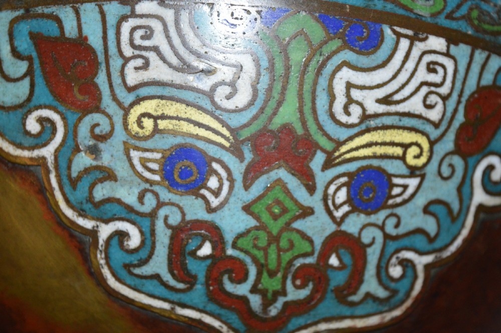 A late 19th-century Chinese bronze vessel decorated with cloisonne enamel bat motifs and geometric patterns in turquoise, blue, red, and yellow. View V