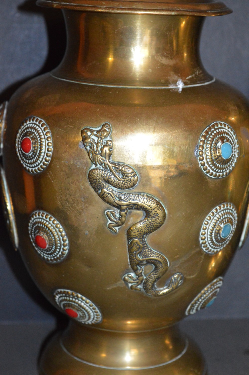 A matching pair of polished brass baluster vases featuring applied serpentine dragon motifs and circular beaded medallions set with turquoise and coral cabochons. View III