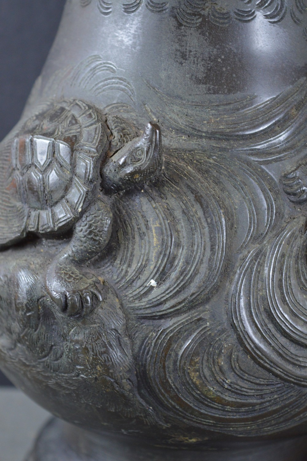 A pair of dark patinated Japanese bronze vases featuring high-relief carvings of flying birds and long-tailed turtles amongst stylised water waves. View IV