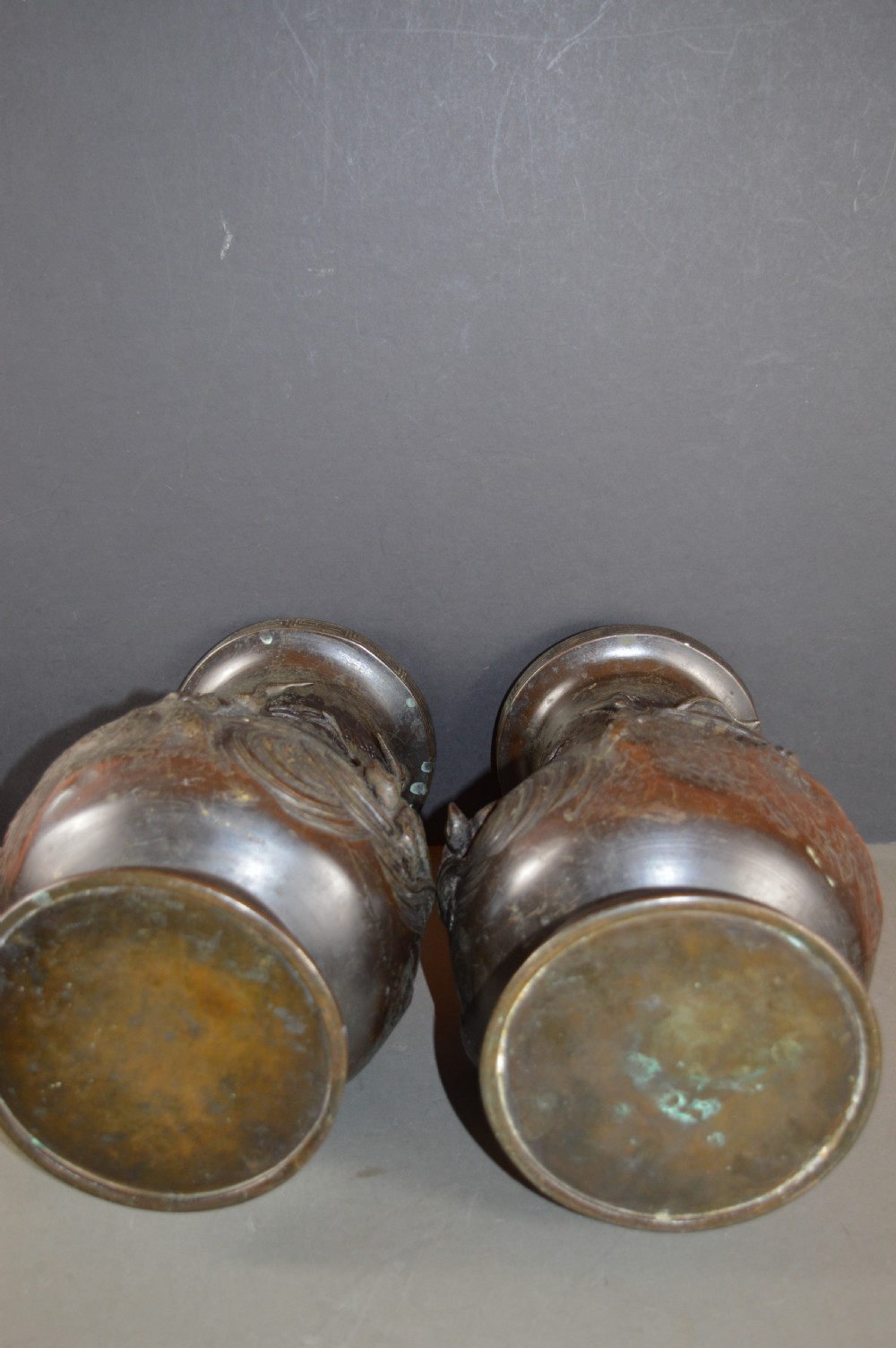 A pair of dark patinated Japanese bronze vases featuring high-relief carvings of flying birds and long-tailed turtles amongst stylised water waves. View XI