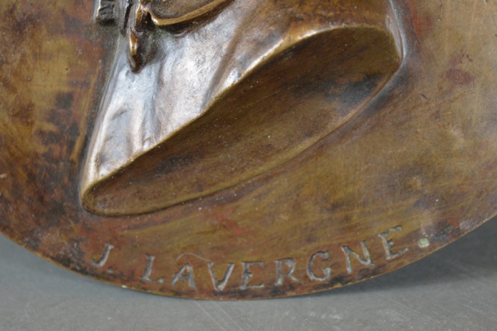 A circular patinated bronze relief plaque displaying a left-facing profile portrait of a man with a moustache, high collar, and bowtie, inscribed F George 1856. View IV