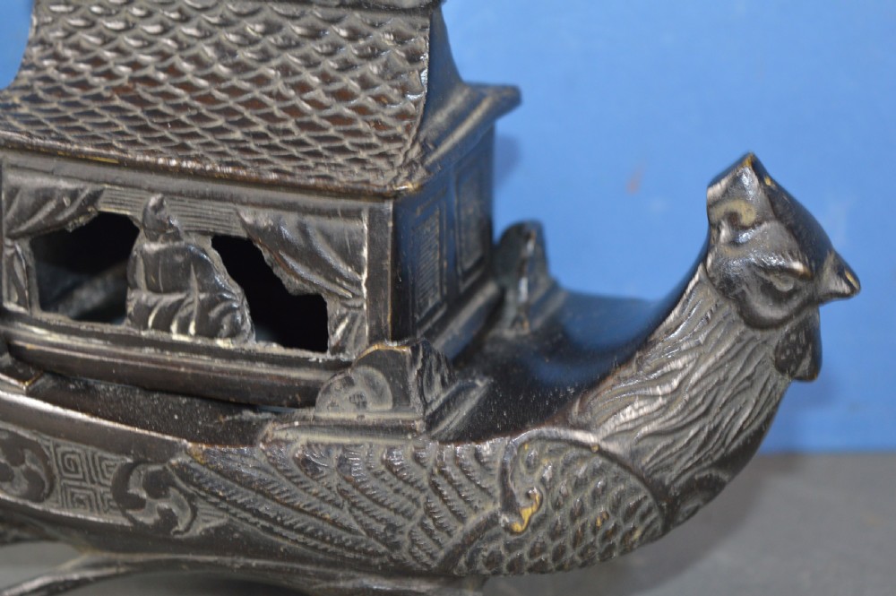 A dark patinated bronze Chinese censer cast in the form of a junk boat featuring a pagoda cabin, figure, and bird prow. View III