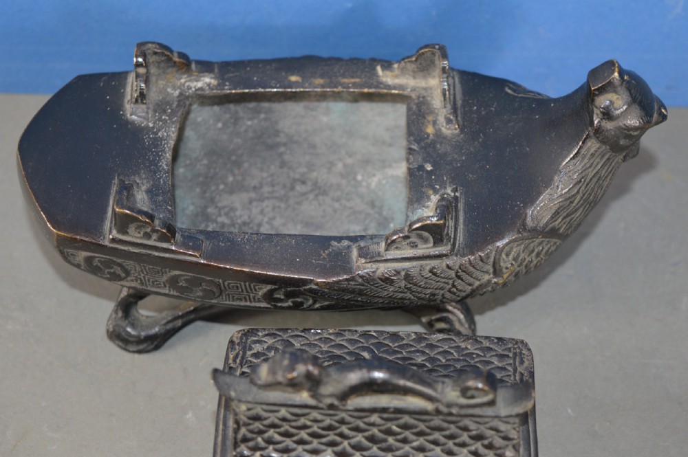 A dark patinated bronze Chinese censer cast in the form of a junk boat featuring a pagoda cabin, figure, and bird prow. View V