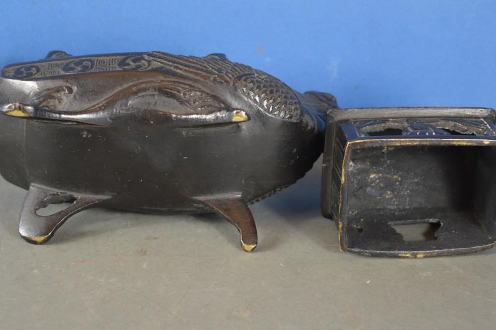 A dark patinated bronze Chinese censer cast in the form of a junk boat featuring a pagoda cabin, figure, and bird prow. View VII