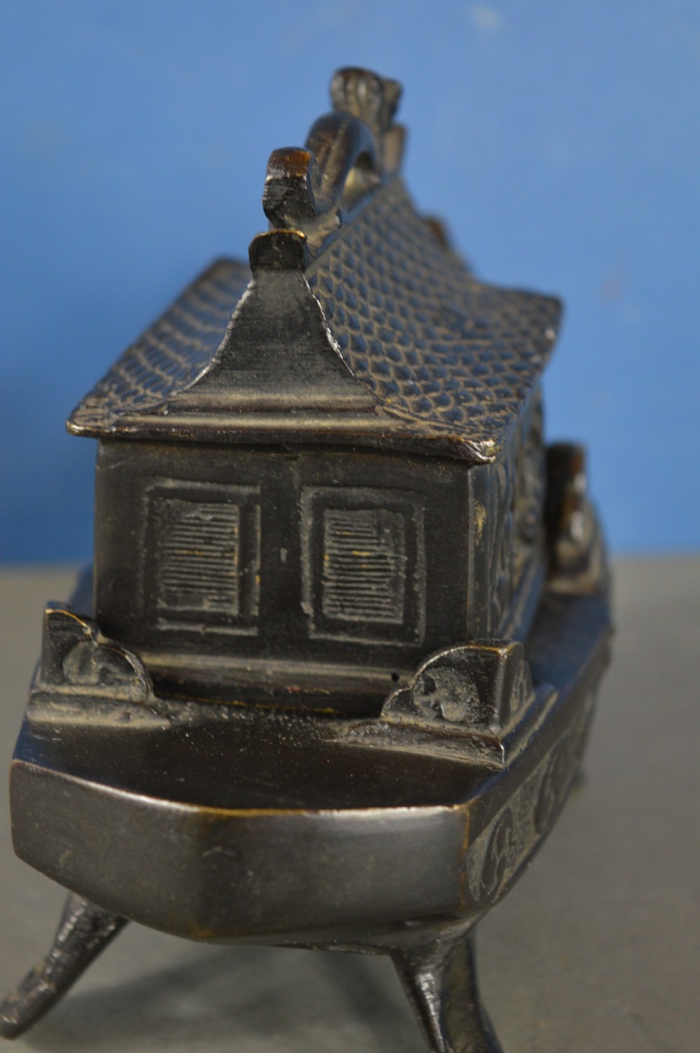 A dark patinated bronze Chinese censer cast in the form of a junk boat featuring a pagoda cabin, figure, and bird prow. View XI