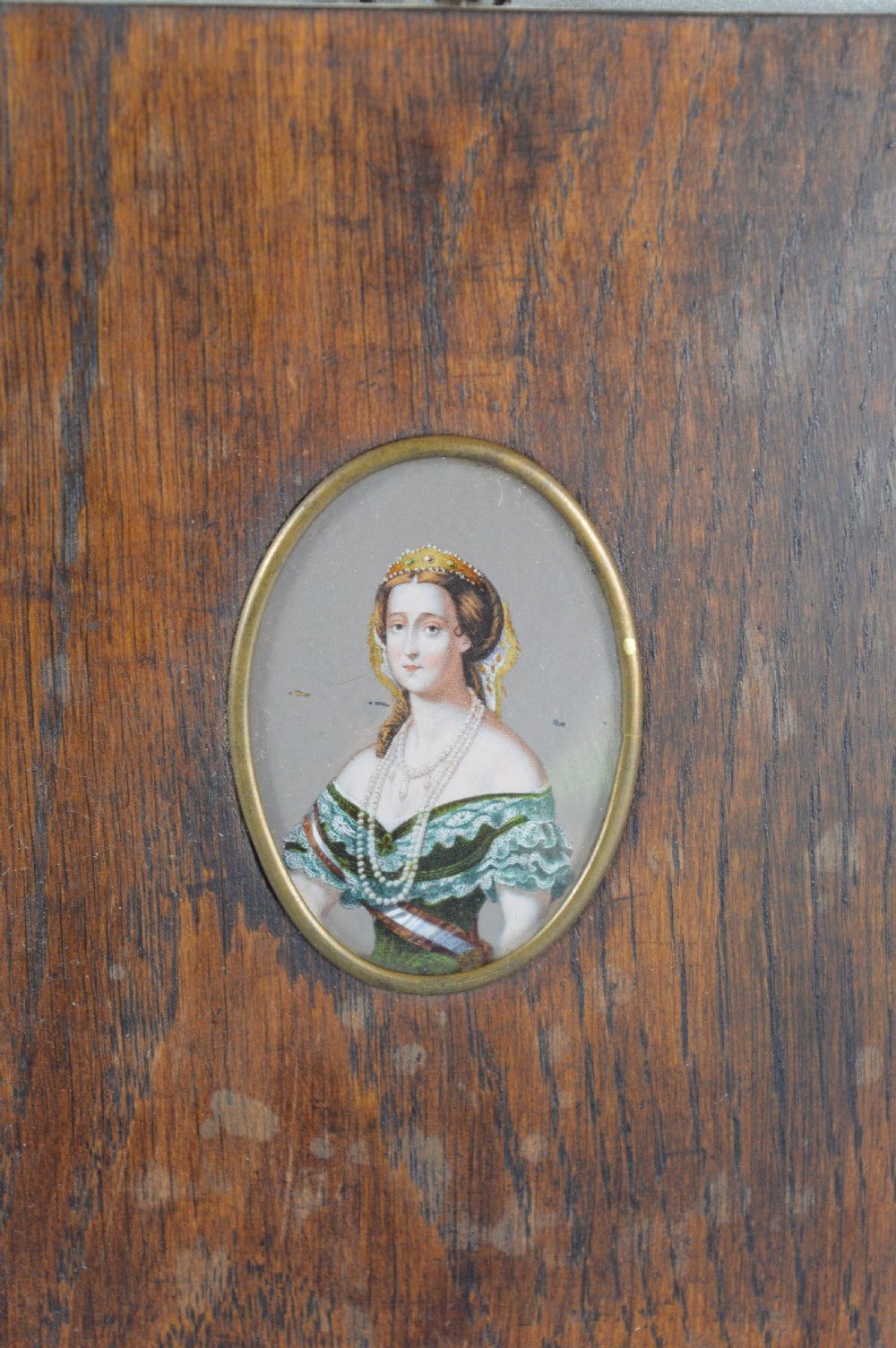 A pair of rectangular wooden plaque frames holding oval hand-painted portrait miniatures of Napoleon and Empress Eugenie within brass bezels. View III