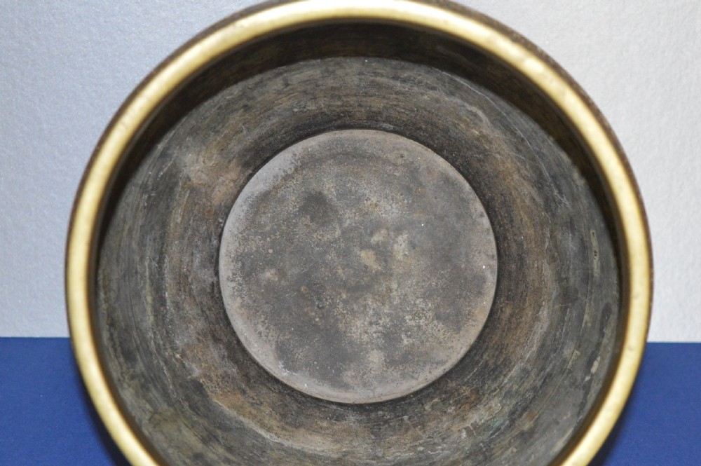 A rounded antique Chinese bronze and cloisonne enamel bowl featuring turquoise ground with floral scroll patterns and a brass rim and base. View V