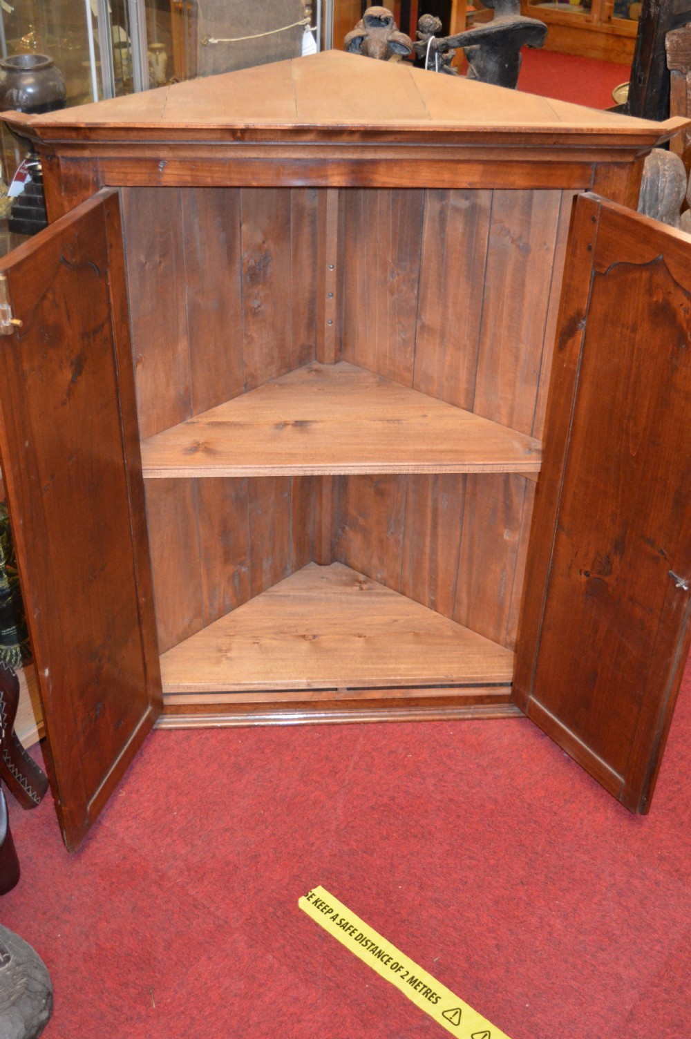 A nineteenth-century mahogany corner hanging cupboard featuring twin panelled doors with inlaid star motifs and brass H-hinges. View VI