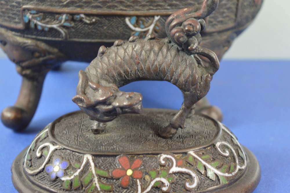 A late nineteenth-century Japanese bronze tripod censer featuring polychrome cloisonne enamel work, relief panels depicting a sailboat, loop handles, and a cover topped with a beast finial. View III