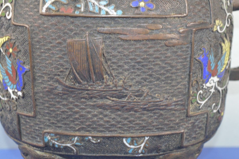 A late nineteenth-century Japanese bronze tripod censer featuring polychrome cloisonne enamel work, relief panels depicting a sailboat, loop handles, and a cover topped with a beast finial. View IV
