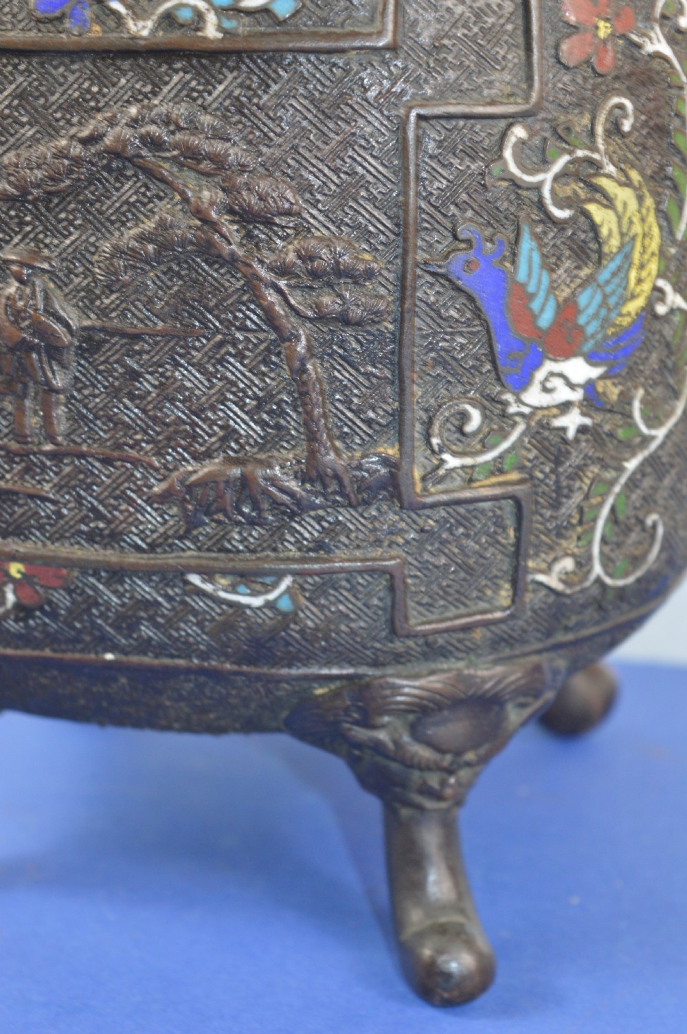 A late nineteenth-century Japanese bronze tripod censer featuring polychrome cloisonne enamel work, relief panels depicting a sailboat, loop handles, and a cover topped with a beast finial. View VIII