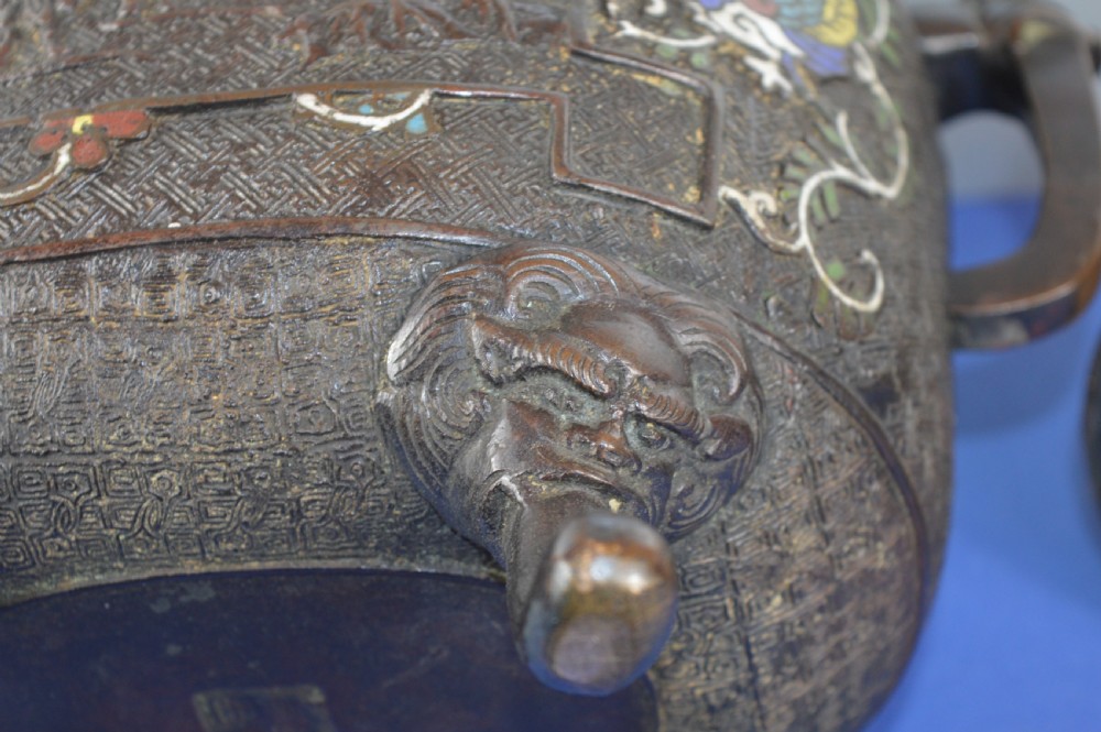 A late nineteenth-century Japanese bronze tripod censer featuring polychrome cloisonne enamel work, relief panels depicting a sailboat, loop handles, and a cover topped with a beast finial. View XIII