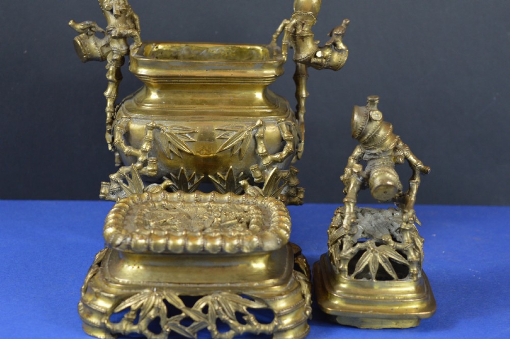 An ornate 19th-century Chinese cast bronze censer featuring bamboo leaf reliefs, sculpted handles, a pierced lid, and an intricate tiered base. View II