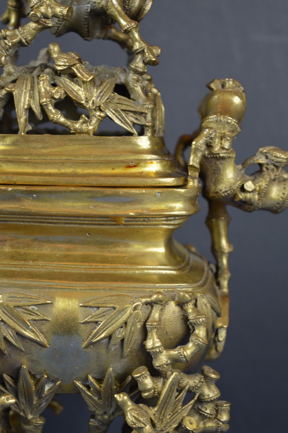 An ornate 19th-century Chinese cast bronze censer featuring bamboo leaf reliefs, sculpted handles, a pierced lid, and an intricate tiered base. View IV
