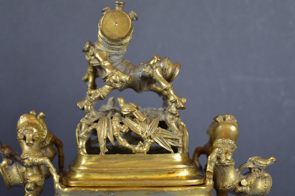 An ornate 19th-century Chinese cast bronze censer featuring bamboo leaf reliefs, sculpted handles, a pierced lid, and an intricate tiered base. View V