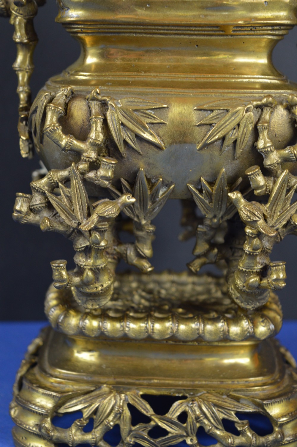 An ornate 19th-century Chinese cast bronze censer featuring bamboo leaf reliefs, sculpted handles, a pierced lid, and an intricate tiered base. View VI