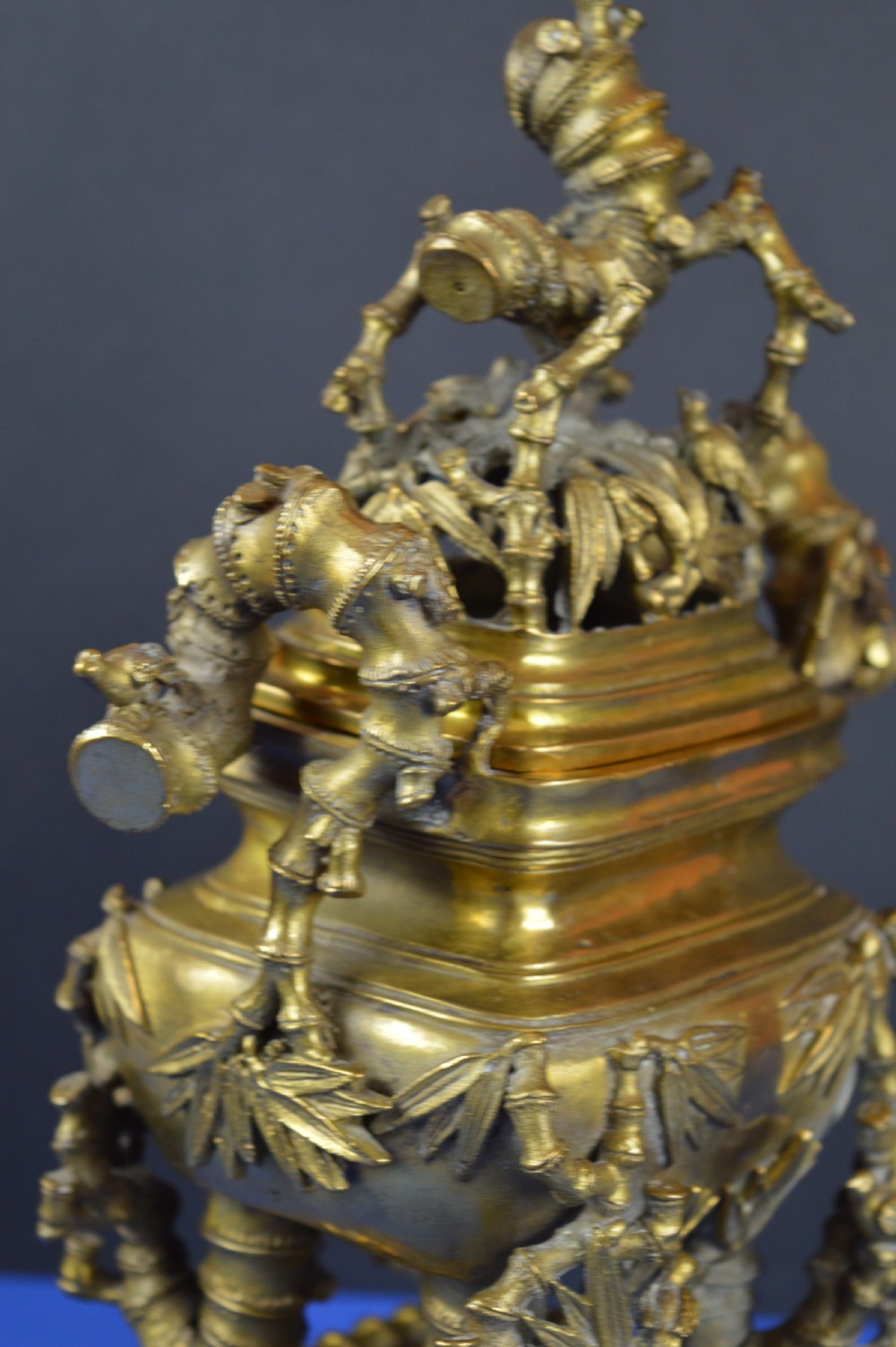 An ornate 19th-century Chinese cast bronze censer featuring bamboo leaf reliefs, sculpted handles, a pierced lid, and an intricate tiered base. View VIII