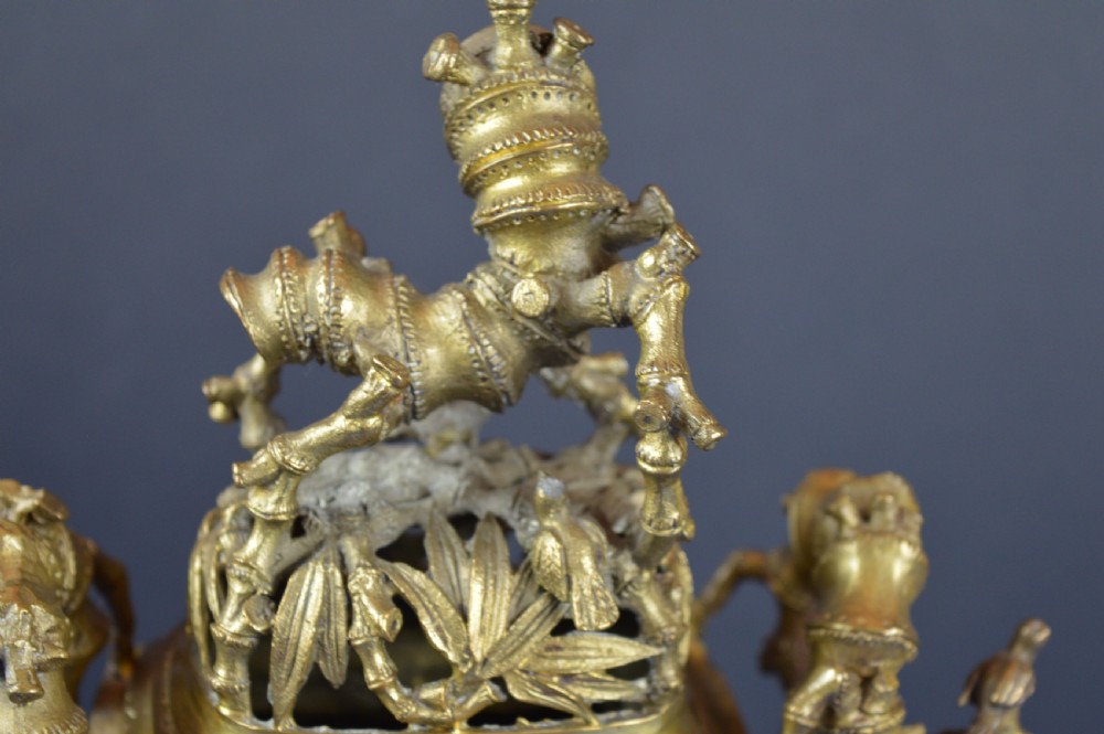 An ornate 19th-century Chinese cast bronze censer featuring bamboo leaf reliefs, sculpted handles, a pierced lid, and an intricate tiered base. View X