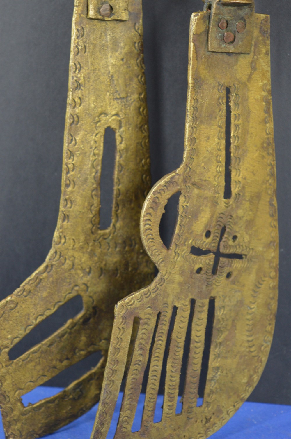 A pair of cast bronze Yoruba ceremonial staffs featuring sculpted human figures as finials above flat, patterned brass blades. View VII