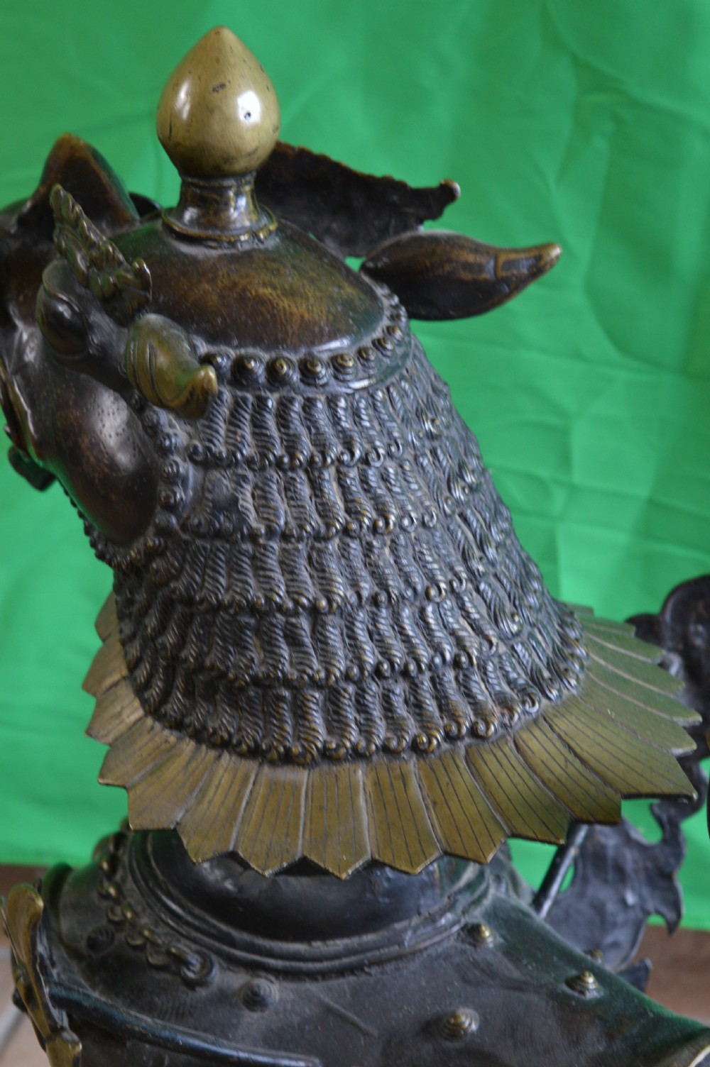 A pair of substantial dark bronze Tibetan temple lions featuring raised tails, stylised scale details, and brass accents. View XII