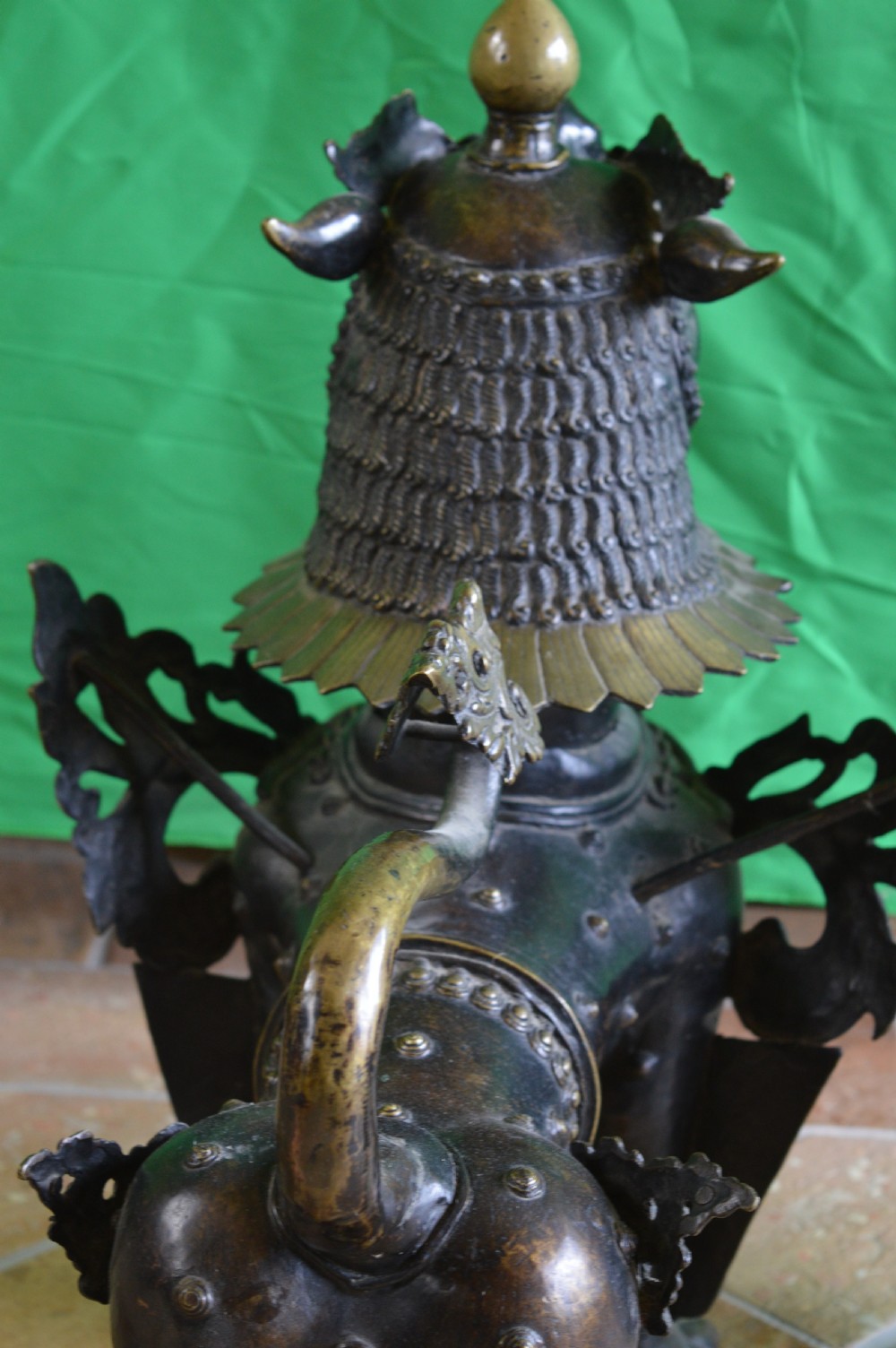 A pair of substantial dark bronze Tibetan temple lions featuring raised tails, stylised scale details, and brass accents. View XVI