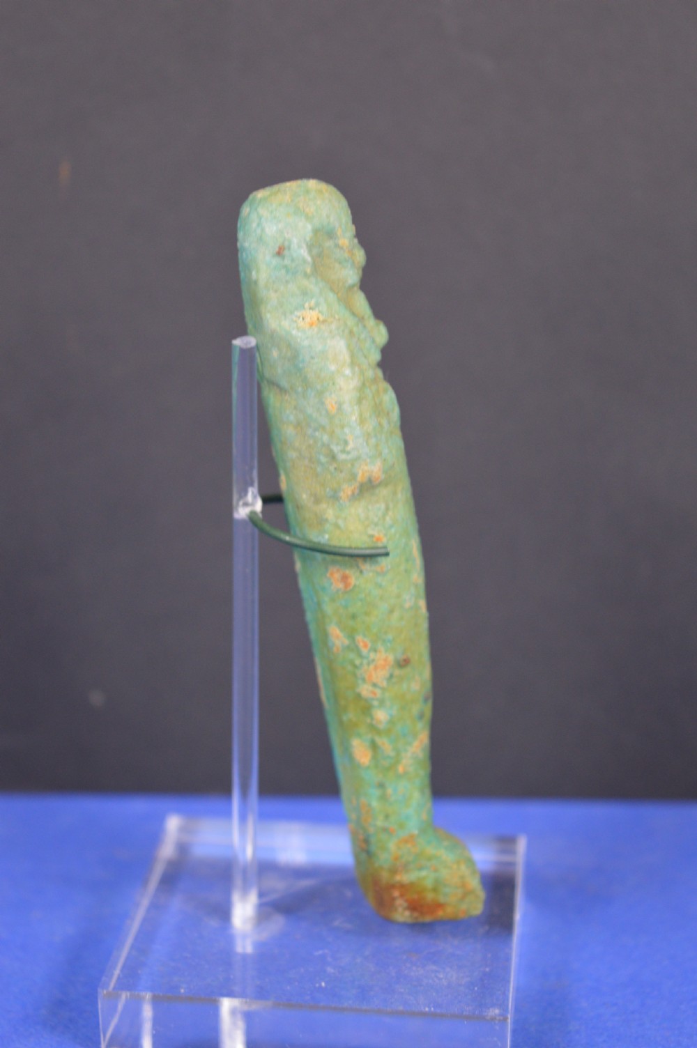 A small ancient Egyptian mummiform shabti statuette crafted from light turquoise green glazed faience. View II