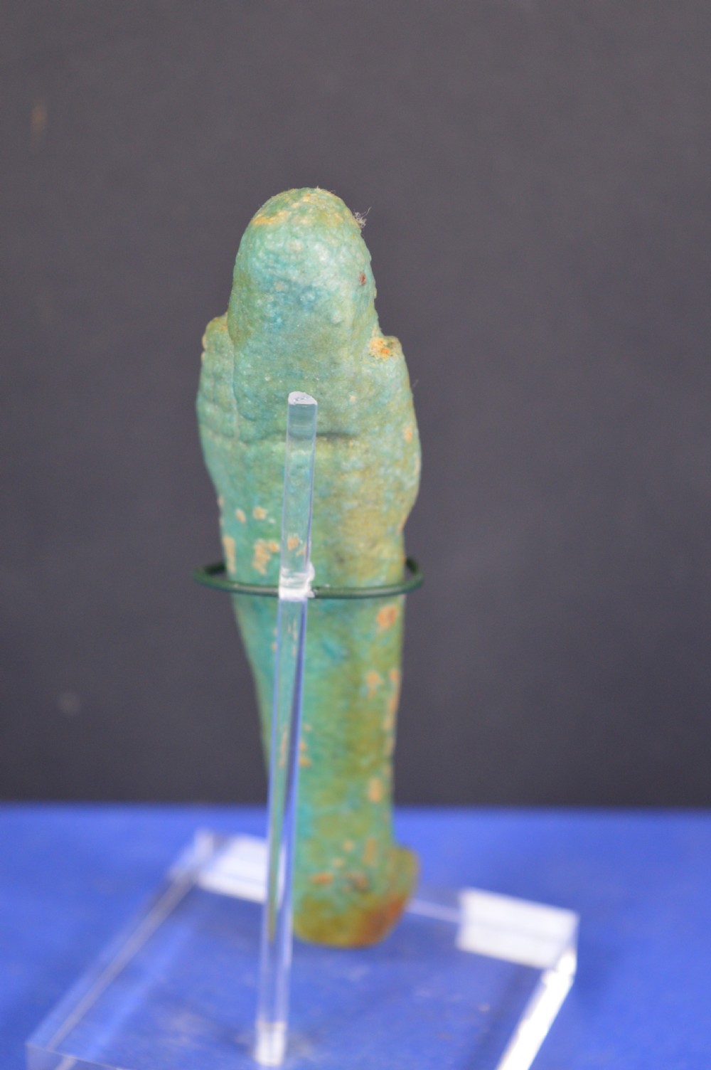 A small ancient Egyptian mummiform shabti statuette crafted from light turquoise green glazed faience. View III