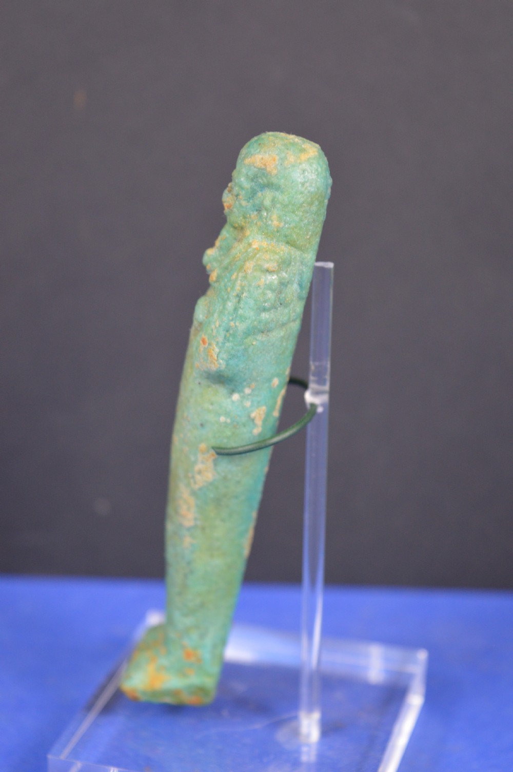A small ancient Egyptian mummiform shabti statuette crafted from light turquoise green glazed faience. View IV