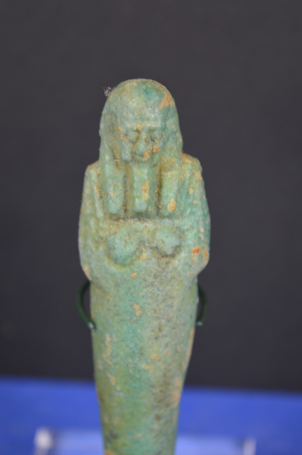 A small ancient Egyptian mummiform shabti statuette crafted from light turquoise green glazed faience. View V