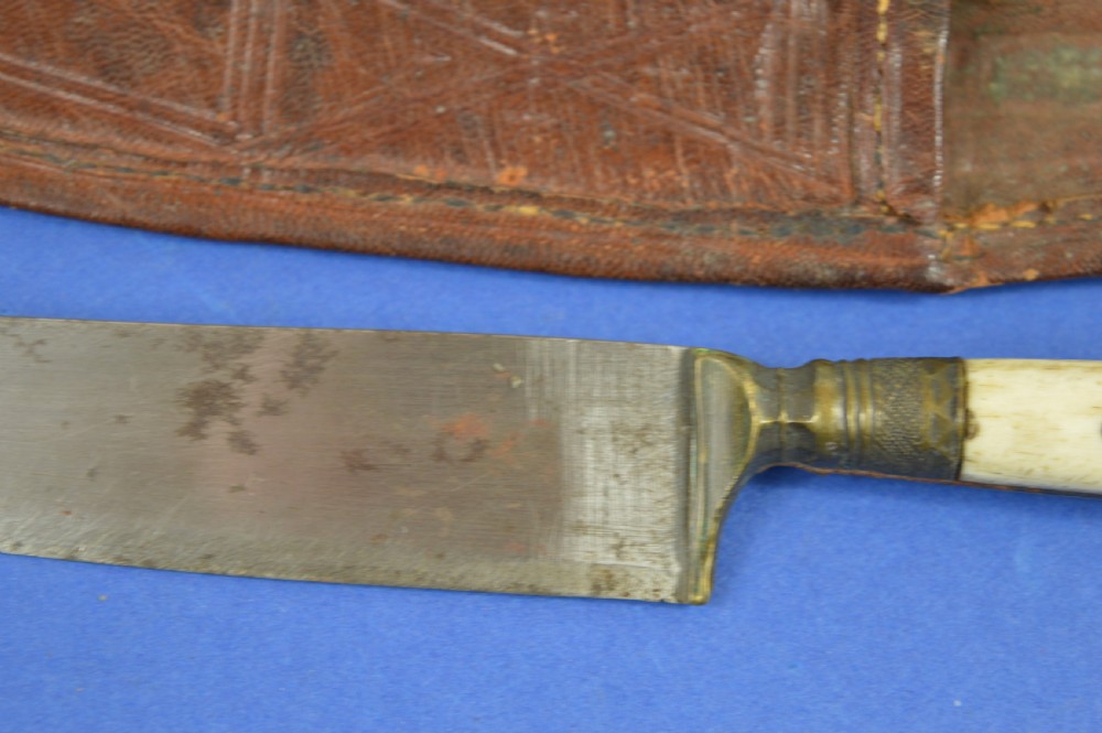 A nineteenth-century Anglo-Afghan war knife featuring a steel blade, a bone handle carved with the word KANDAHAR, and a stamped brown leather sheath. View III