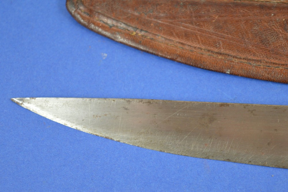 A nineteenth-century Anglo-Afghan war knife featuring a steel blade, a bone handle carved with the word KANDAHAR, and a stamped brown leather sheath. View IV