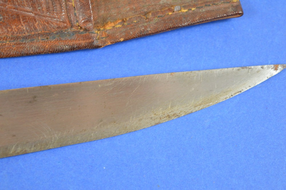 A nineteenth-century Anglo-Afghan war knife featuring a steel blade, a bone handle carved with the word KANDAHAR, and a stamped brown leather sheath. View VIII