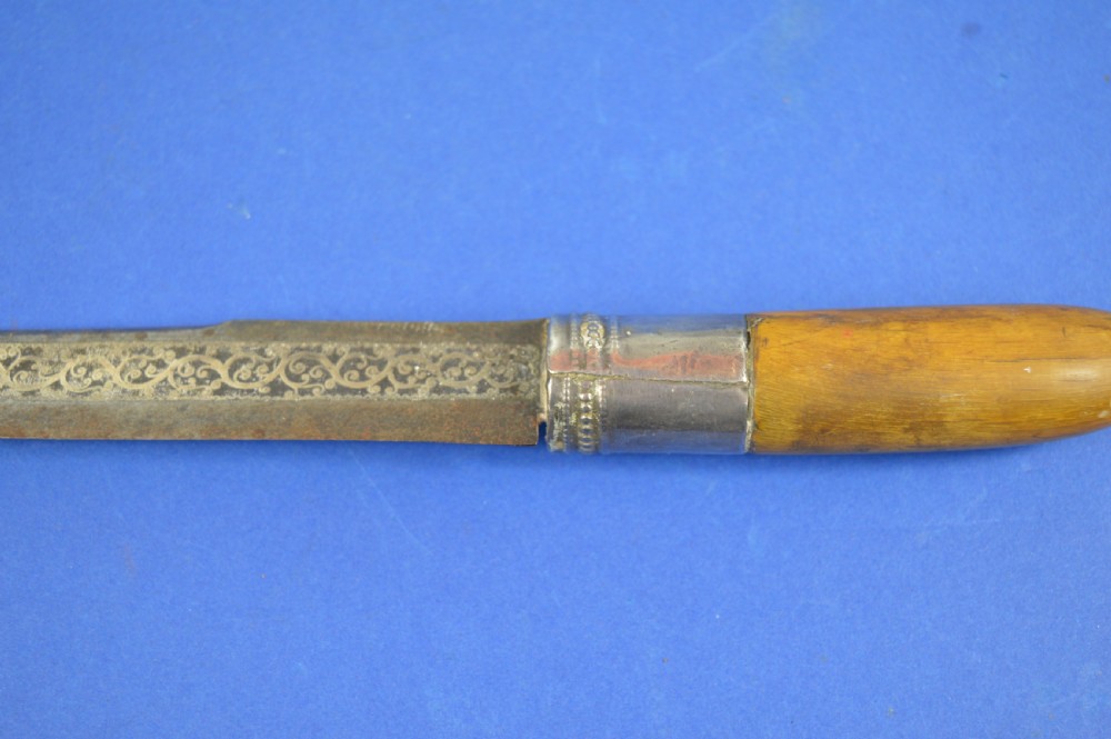 A 19th-century ceremonial knife with a steel blade featuring silver scrollwork inlay, a silver metal collar, and a smooth horn handle. View IV