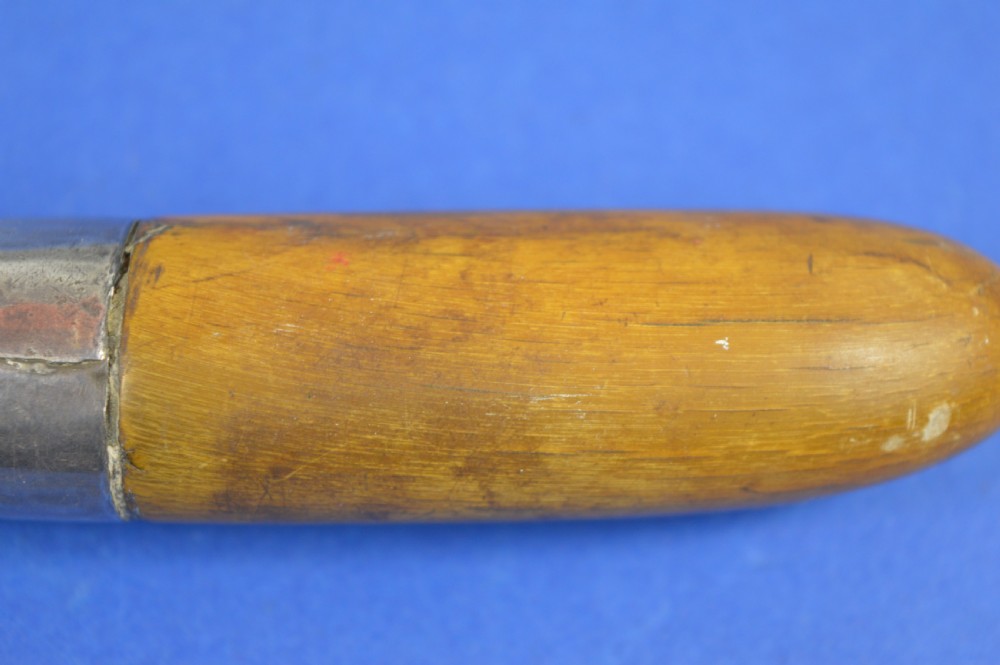 A 19th-century ceremonial knife with a steel blade featuring silver scrollwork inlay, a silver metal collar, and a smooth horn handle. View VI