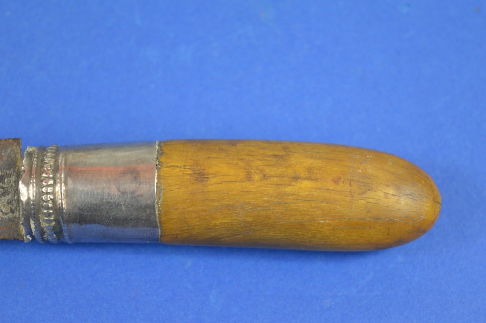 A 19th-century ceremonial knife with a steel blade featuring silver scrollwork inlay, a silver metal collar, and a smooth horn handle. View XI