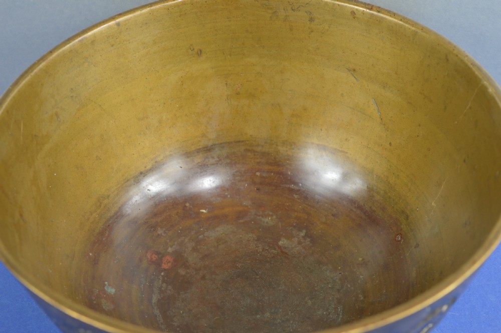 A large circular bronze bowl with relief engravings of figures in a landscape around the exterior and a polished interior. View IV