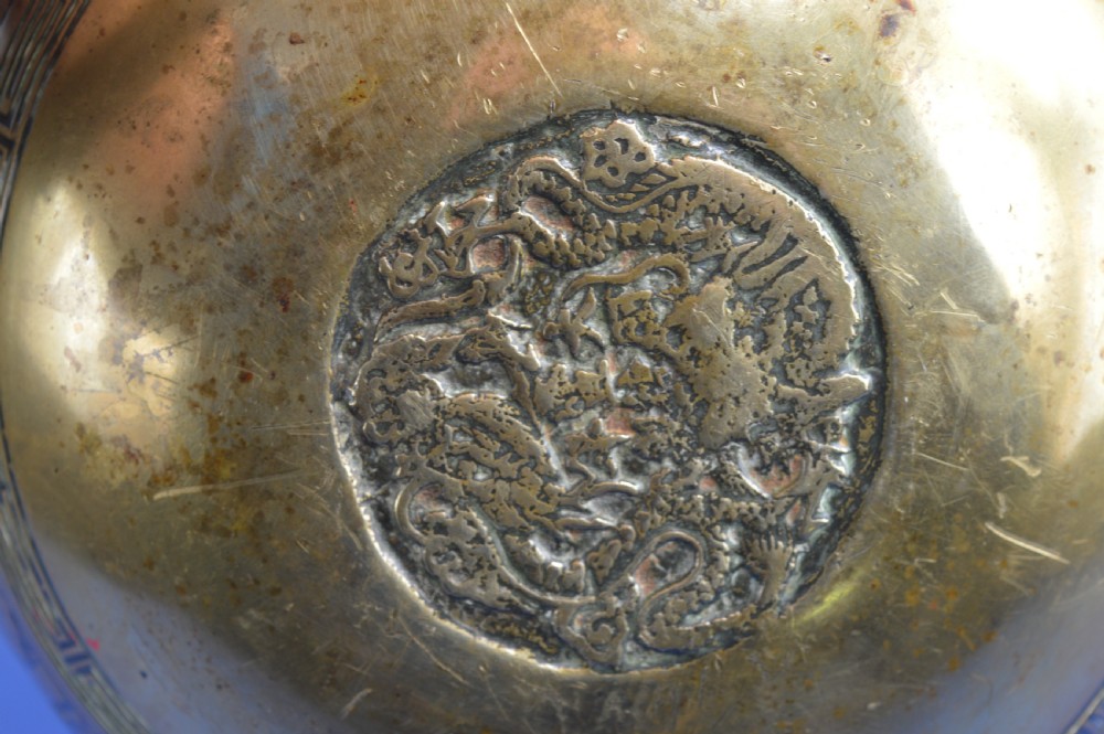 A large circular bronze bowl with relief engravings of figures in a landscape around the exterior and a polished interior. View VII