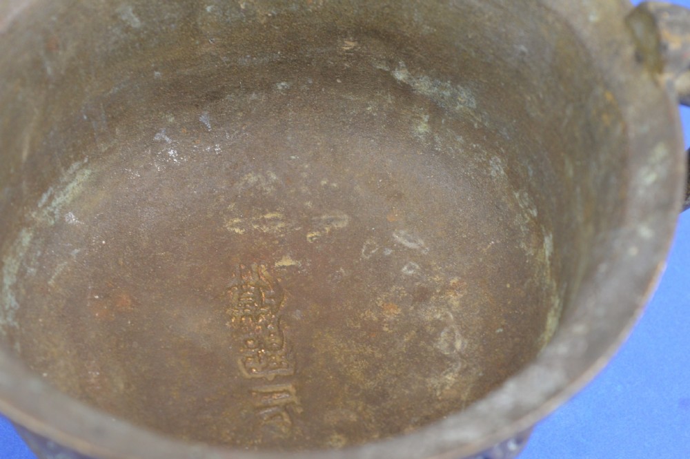 A cast bronze ritual food vessel with two loop handles topped with beast heads, featuring relief carvings and a raised circular base. View XI