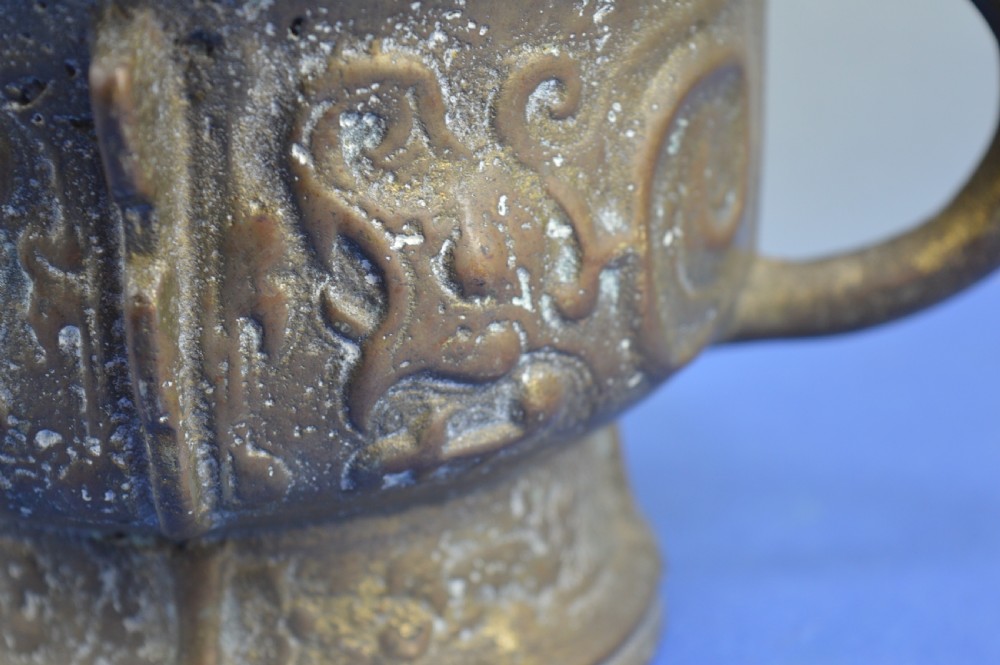 A cast bronze ritual food vessel with two loop handles topped with beast heads, featuring relief carvings and a raised circular base. View XII