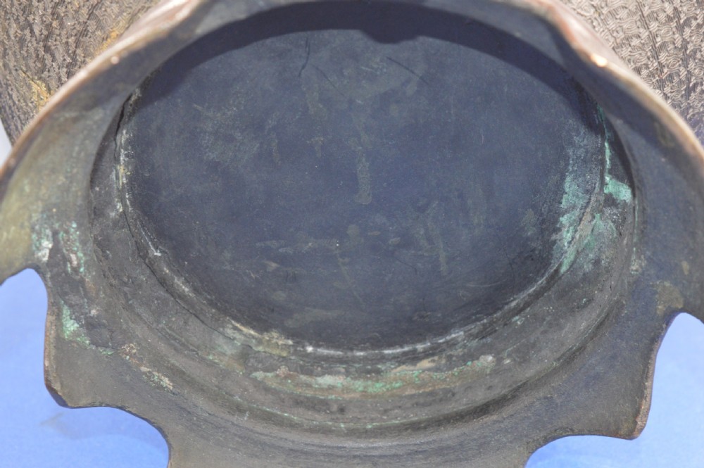 A heavy dark bronze Chinese bowl featuring relief panels with bird and floral motifs, bamboo-style side handles, and a lobed collar over an integral stepped base. View VIII