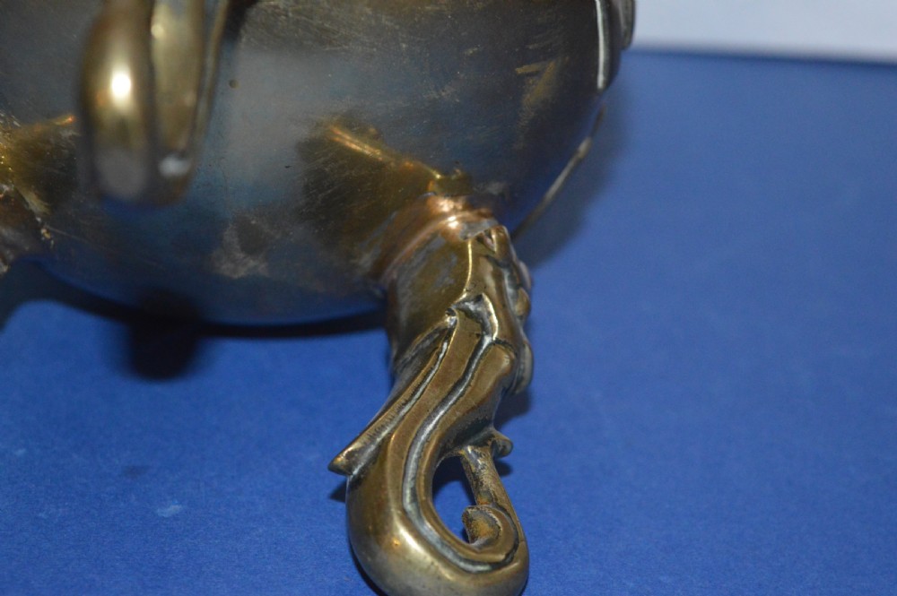 A late nineteenth-century Chinese cast bronze tripod censer featuring raised trigram motifs, upright loop handles, and beast-mask feet. View IX