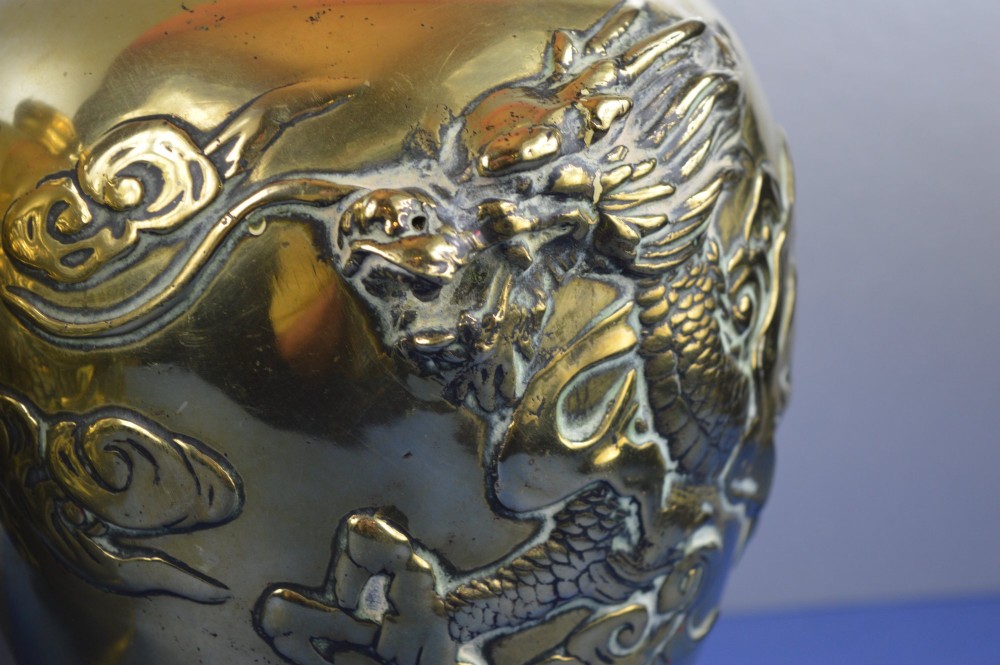 A matching pair of heavy polished gold gilt bronze baluster vases featuring carved high-relief dragons amid swirling cloud motifs. View V