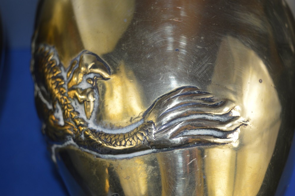 A matching pair of heavy polished gold gilt bronze baluster vases featuring carved high-relief dragons amid swirling cloud motifs. View X